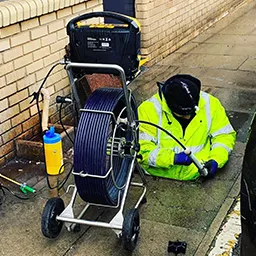 man half in a drain
