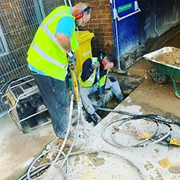 man clearing a drain